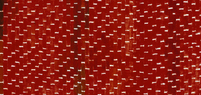 Painting features vertical tile-shaped brushstrokes in various shades of red separated by horizontal white lines. Creating a rhythmic and mosaic-like pattern that resembles stitching, the white lines create stair steps in the lower right corner, separating as they move towards the center.