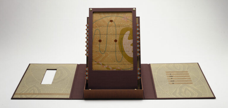 An open maroon portfolio with contents displayed upright in center. Upright panel is an abstract image with red circles connected by a curving green line on a mustard yellow background.