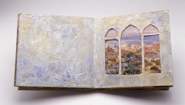 An open textured book with painted, arched window cutouts on the right page, revealing a colorful landscape scene; the left page is blank with a textured, pastel surface.