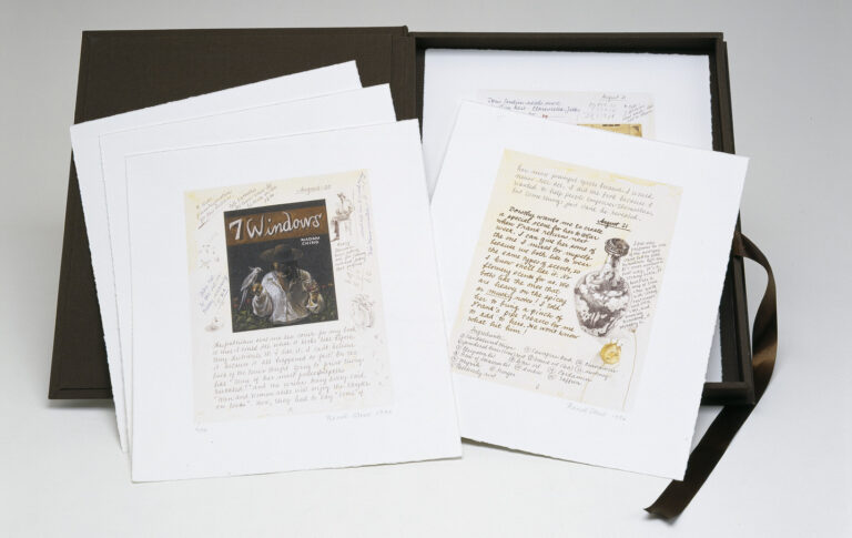 A black portfolio of prints is open, revealing its contents. Three stacked prints are on the left with only the top one visible. To the right, two prints are seen, only the top one completely.