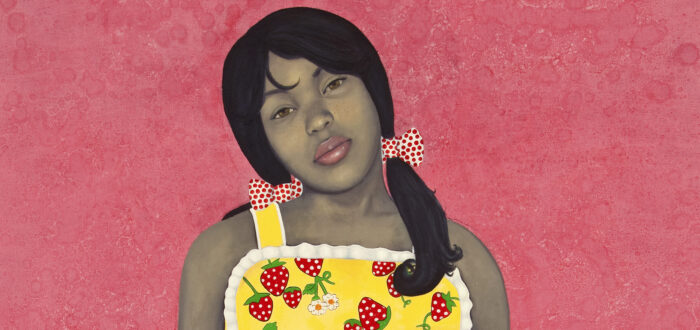 Wearing a bright yellow apron-style dress with strawberries and lace-trim details, an expressionless young woman with medium-dark skin tone rendered in grayscale stares out with her hands in her dress pockets. Her head is cocked to one side against an intensely pink-colored background.