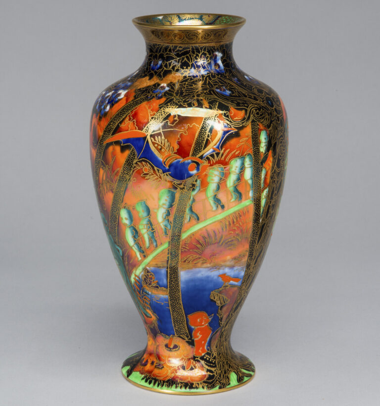 A shiny vase with vibrant oranges, blues, greens, and gold accents with wide shoulders and a narrow neck, edged in gold.