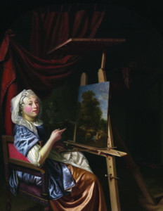 A woman in historical clothing sits at an easel, painting a landscape. She looks at the viewer, pointing at her artwork. The scene is set indoors with dark drapery and a shelf in the background.