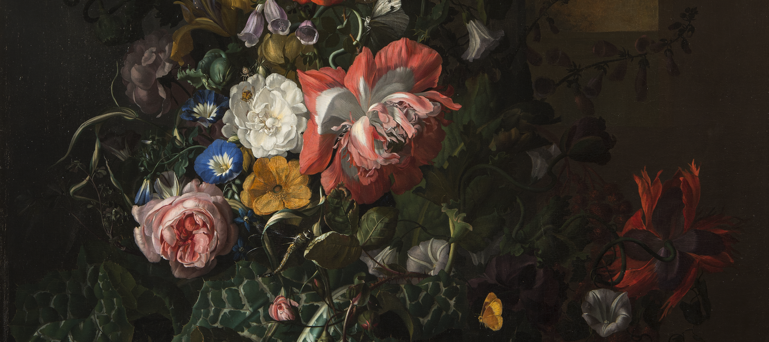 A still-life painting featuring an asymmetrical arrangement of flowers; the central section features pink, orange, yellow, and blue flowers and is dramatically highlighted compared to the background and outer edge of arrangement.