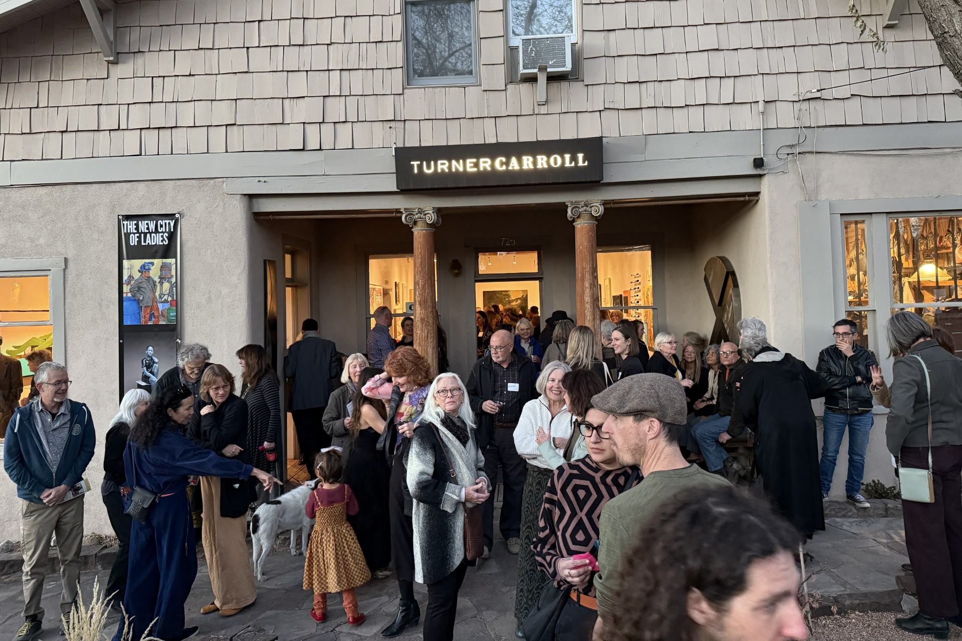 Crowd gathers outside the Turner Carroll Gallery in Santa Fe for the New Mexico State Committee of NMWA inaugural artist registry exhibition.